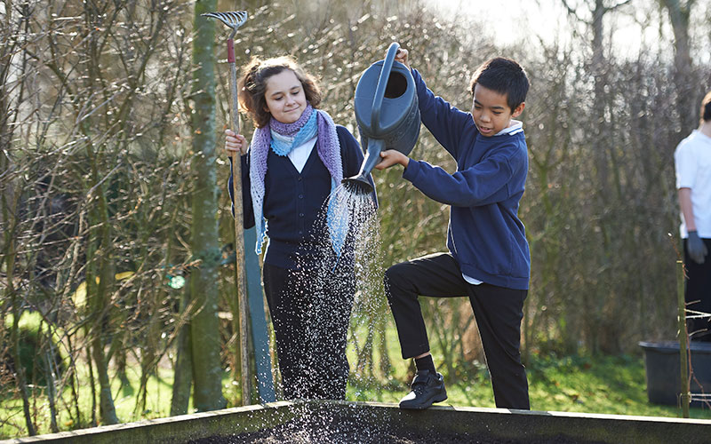 Children watering in the garden