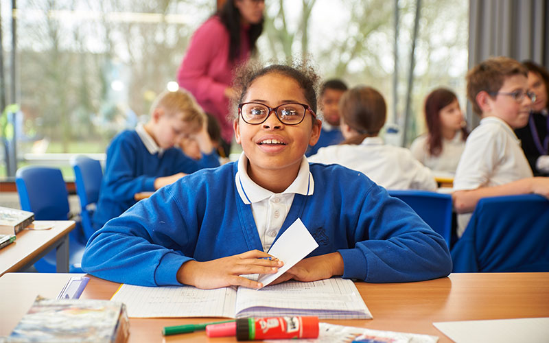 Girl in class with book